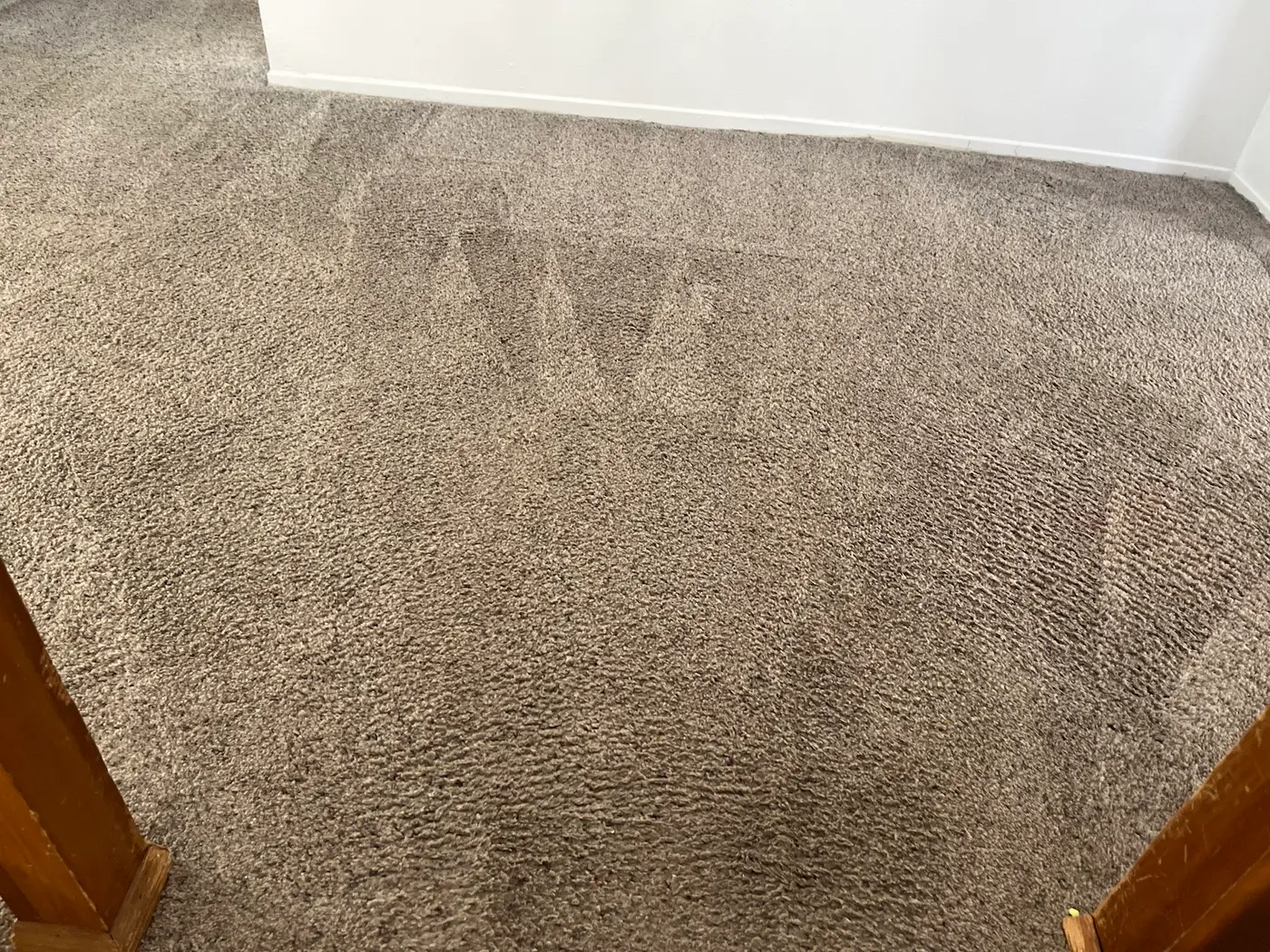 Carpet with a red spot beside the cleaned carpet after cleaning