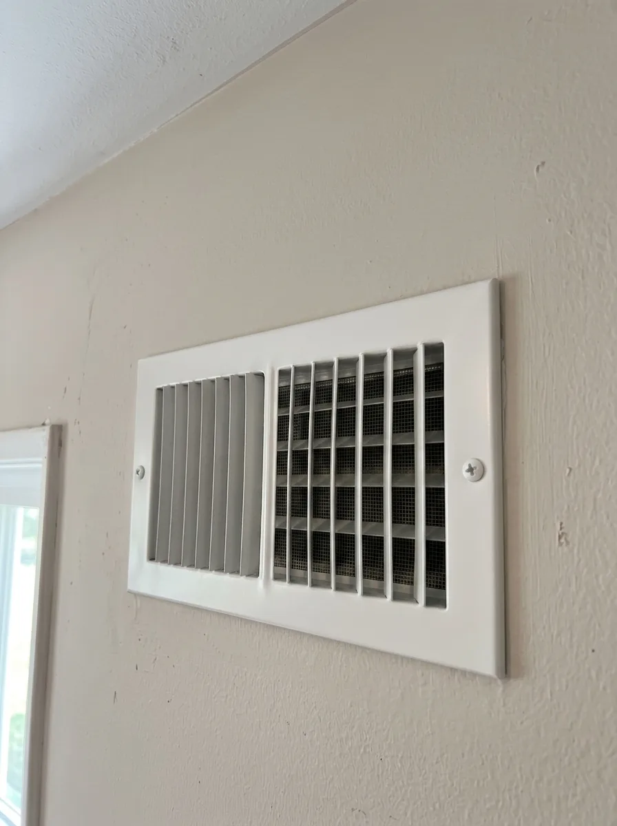 Wall supply register, a dust-caked grille beside the cleared register after cleaning