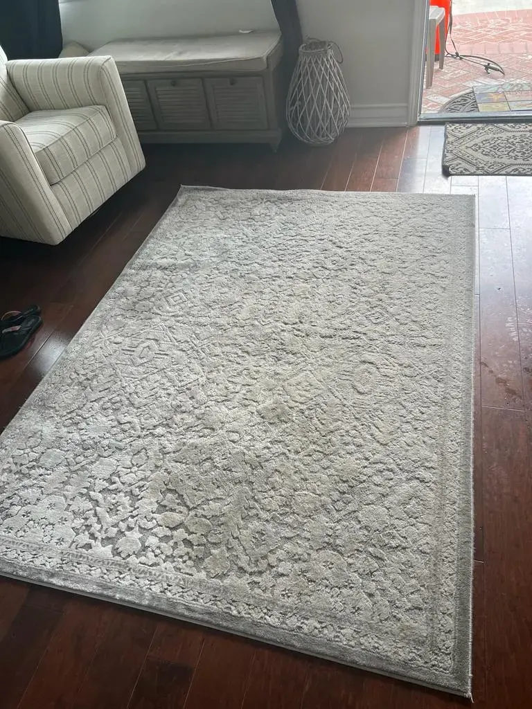 Area rug cleaned and returned to a hardwood floor